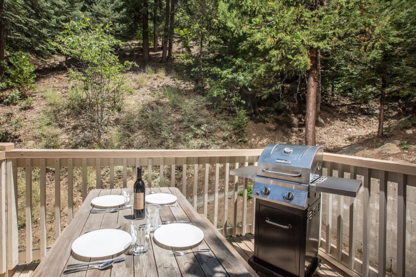 Photo of private deck with table and barbecue grill