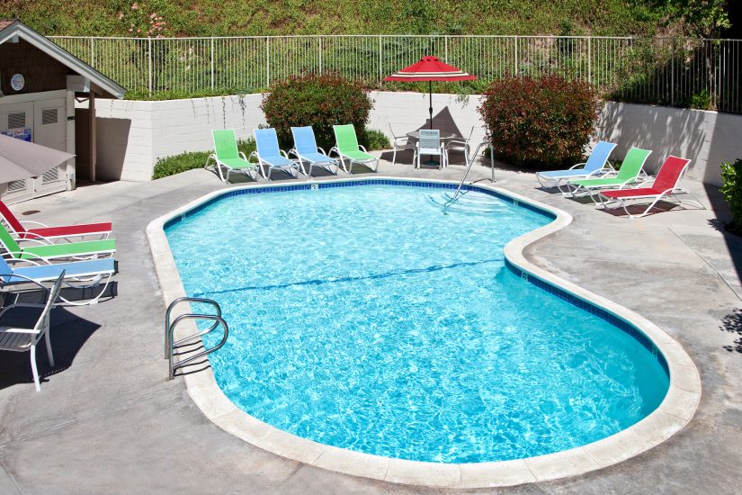 Photo of Swimming pool with colorful lounging chairs